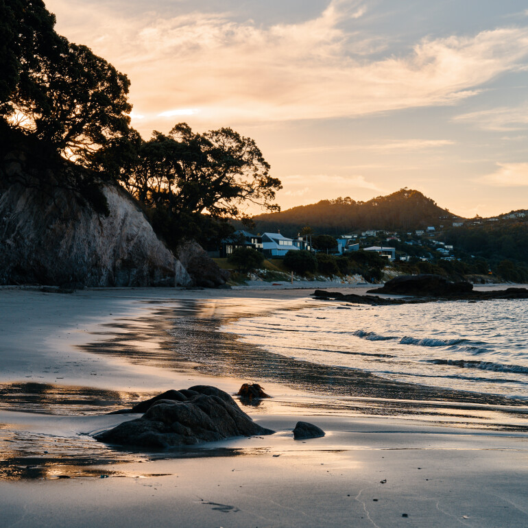 Sunset behind Hahei Beach cliffs